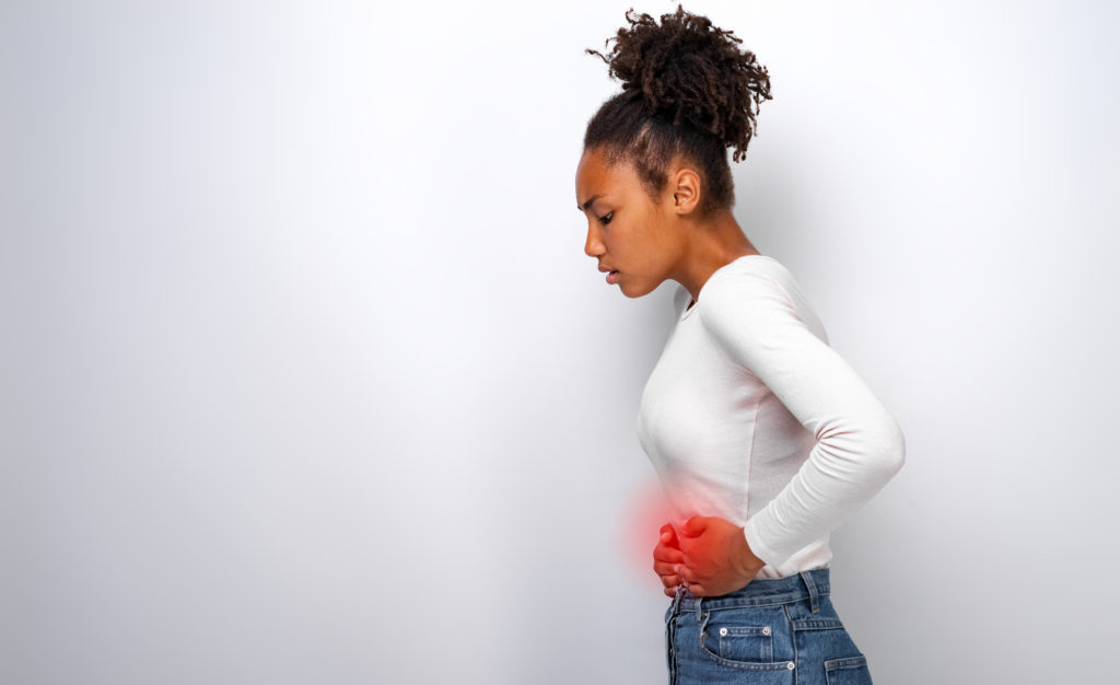 Image of profile of sick woman having a stomach ache, left side